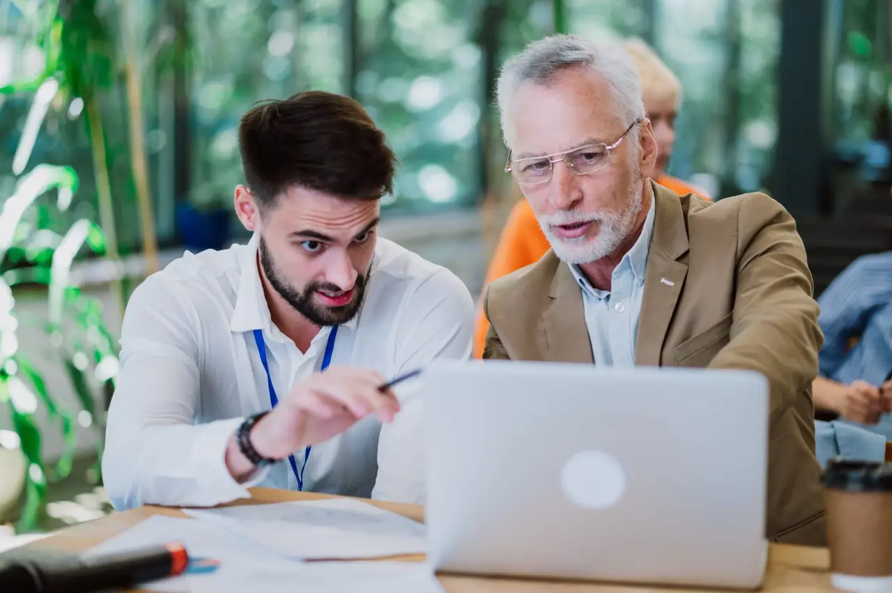 friends using laptop while sitting table scaled@0.5x